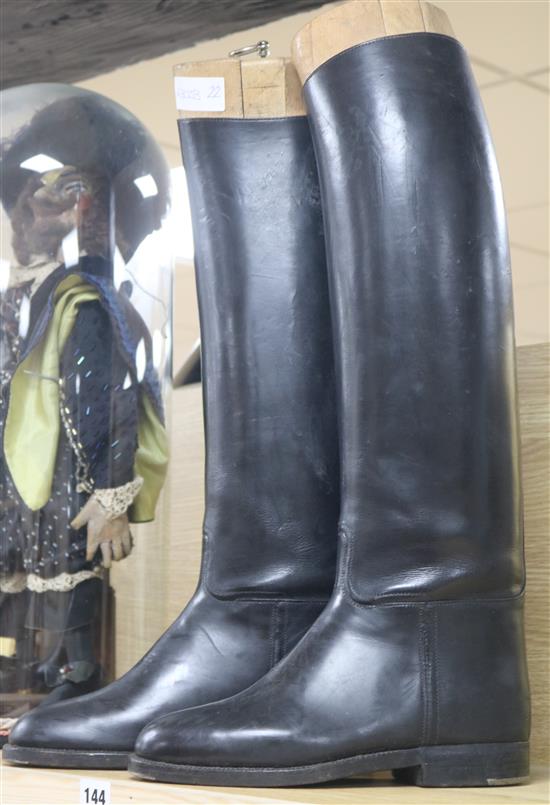 A pair of leather riding boots with boot stretchers